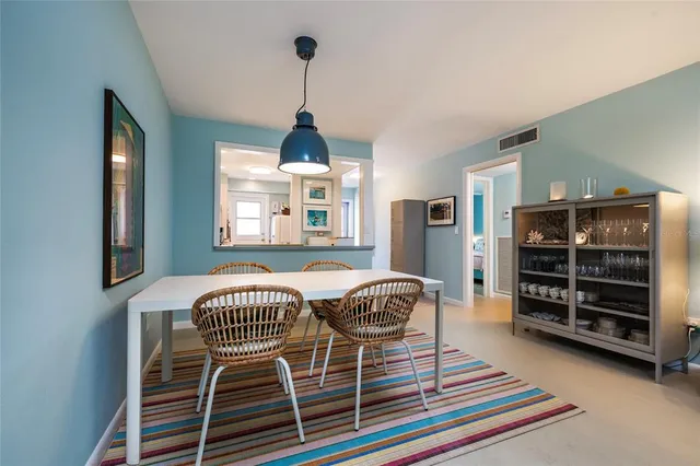 a kitchen with white cabinets and window