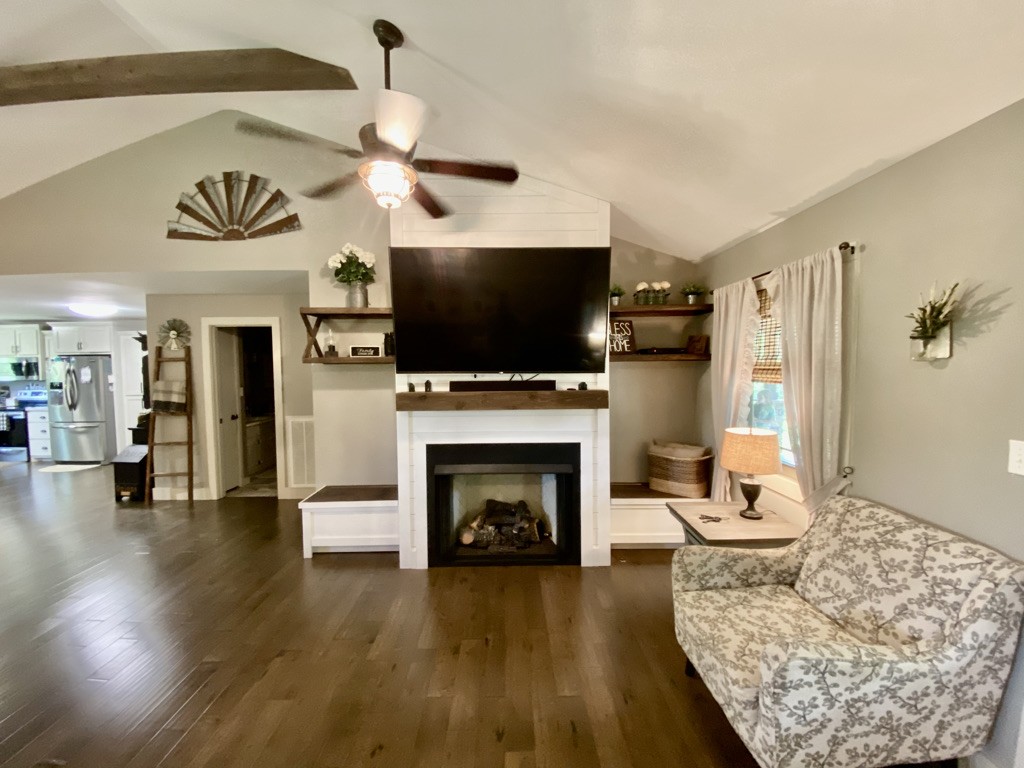 560 Butler Bridge Road Portland, TN 37148 - Photo 4 of 26 a living room with furniture a fireplace and a flat screen tv