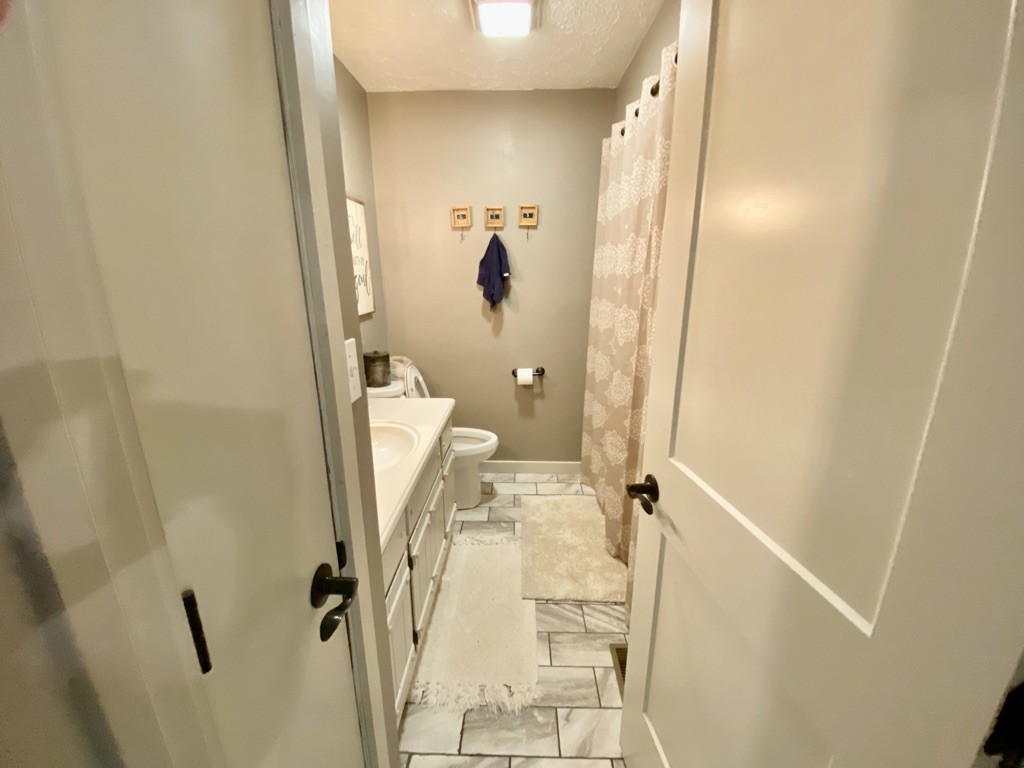 560 Butler Bridge Road Portland, TN 37148 - Photo 5 of 26 wooden floor in a bathroom next to a sink