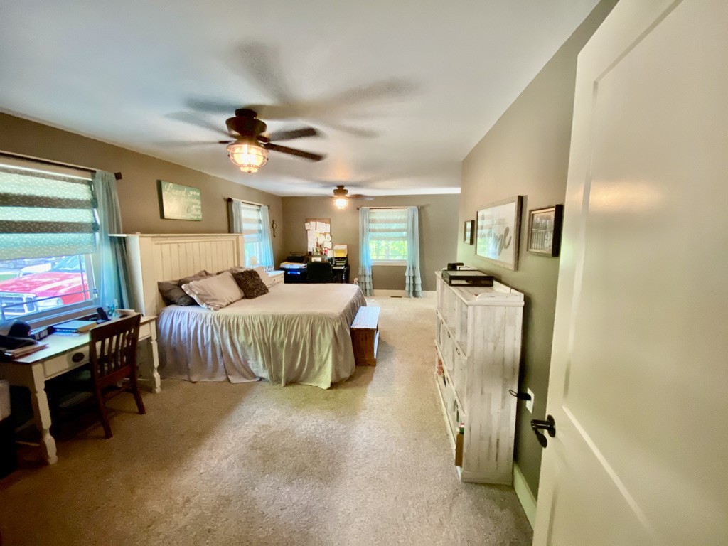 560 Butler Bridge Road Portland, TN 37148 - Photo 6 of 26 a bedroom with bed and a chandelier