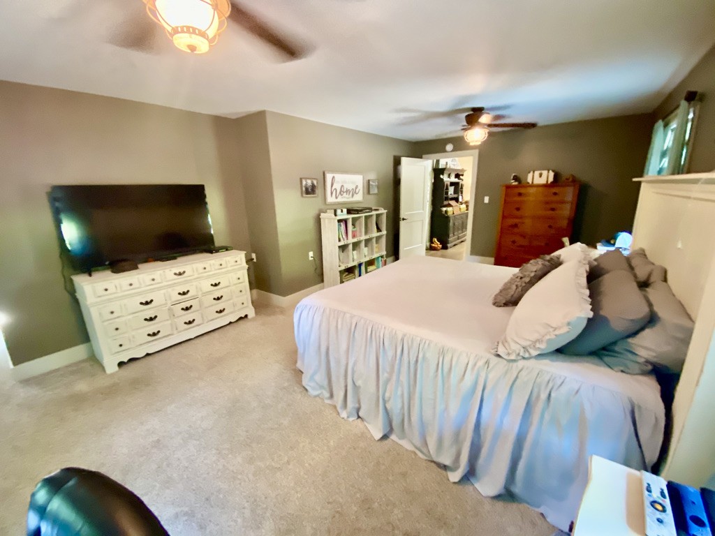 560 Butler Bridge Road Portland, TN 37148 - Photo 7 of 26 a bedroom with a large bed and a flat tv screen on dresser