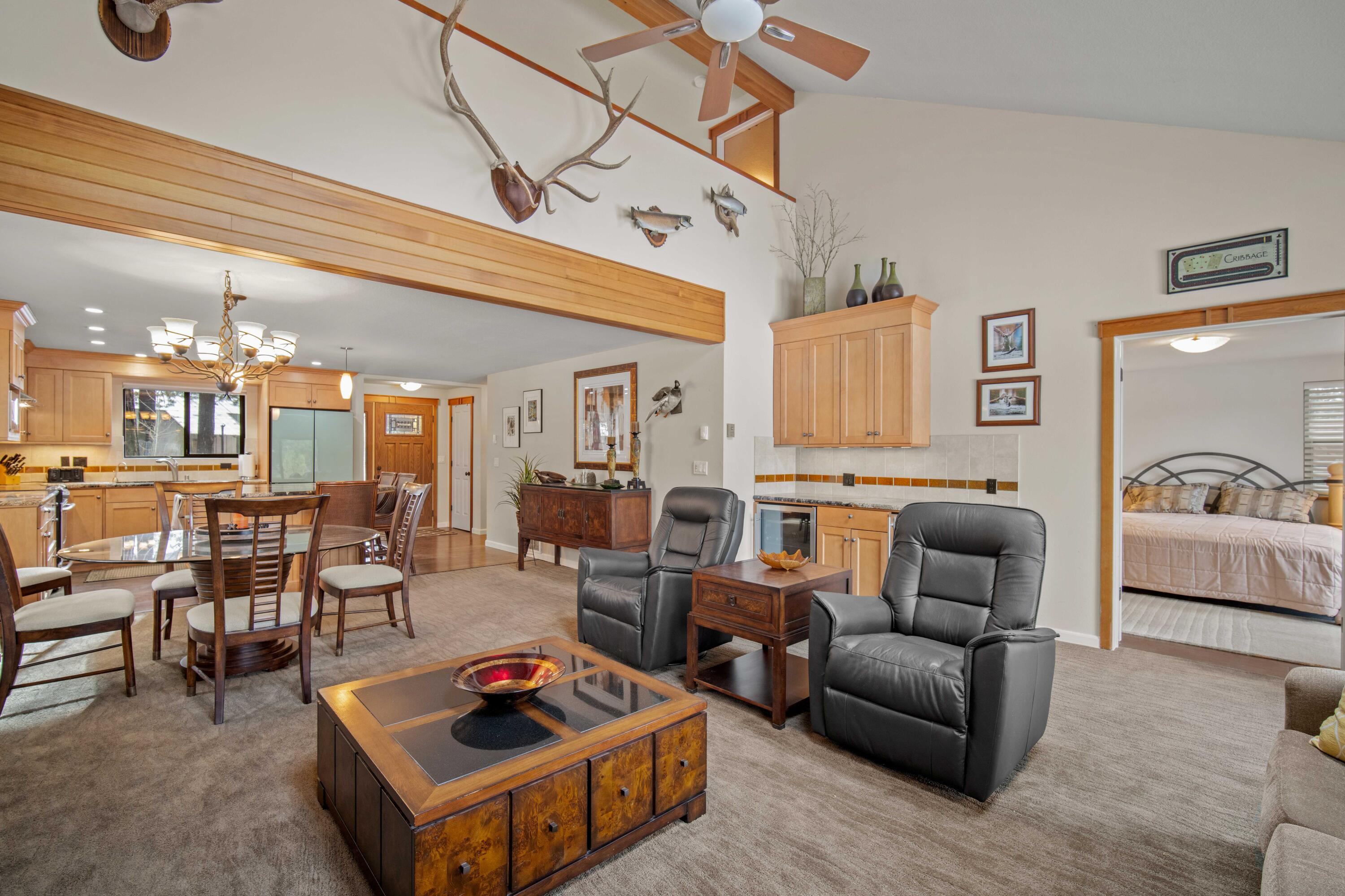56019 Snow Goose Road Bend, OR 97707 - Photo 18 of 32 a living room with furniture and a chandelier
