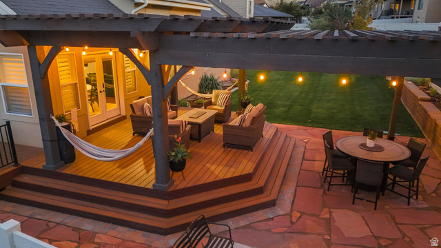 14738 Tangle Hill Road Herriman, UT 84096 - Photo 9 of 66 Multi-tiered outdoor living area featuring a wood-finish deck with integrated steps, an overhead pergola, and flagstone patio