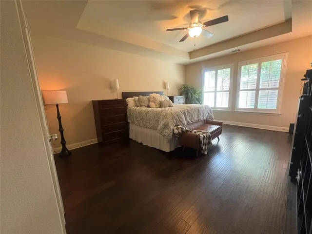 a spacious bedroom with a bed and a chandelier