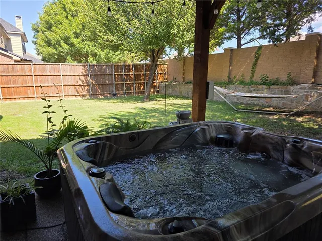 a view of a backyard with plants and a patio