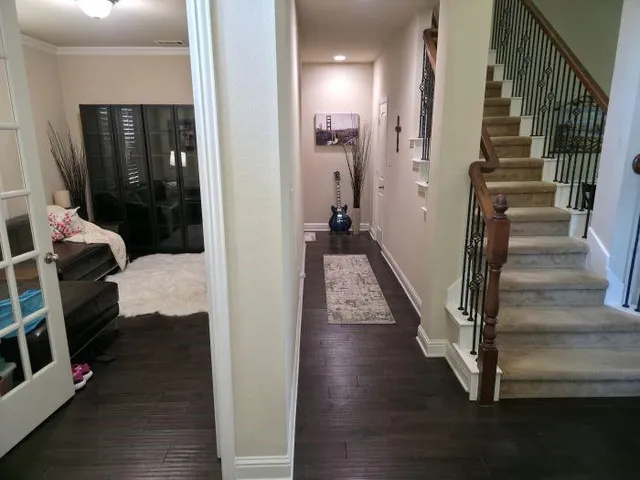a view of entryway and hall with wooden floor