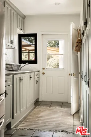 a view of a kitchen that has a sink and a stove in it