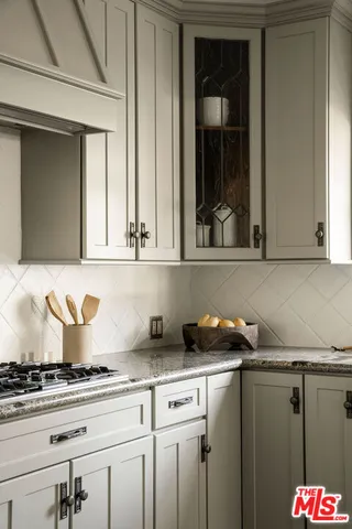 a kitchen with a stove and a window