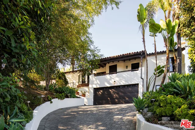 a view of a white house with a large tree and a yard
