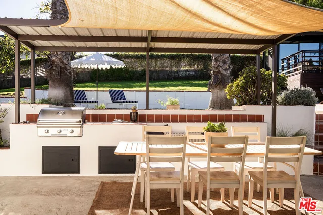 a view of swimming pool with chairs and wooden fence