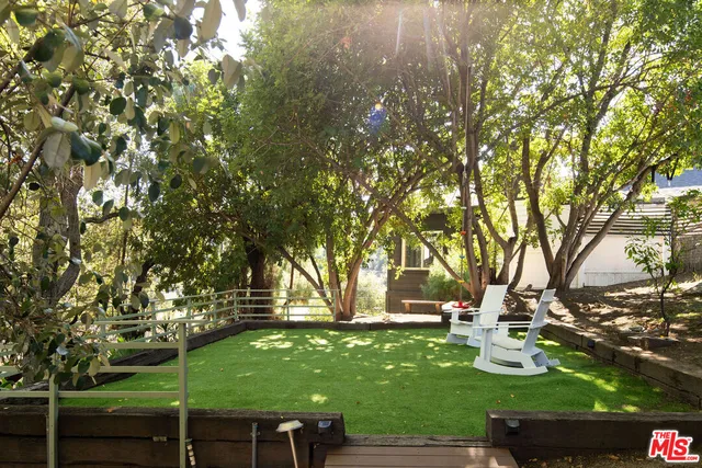 a backyard of a house with table and chairs