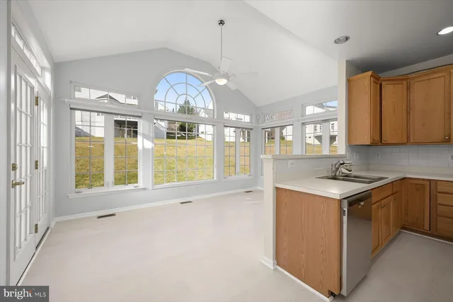 a view of a livingroom with wooden floor and a fireplace