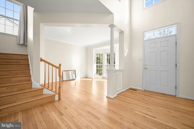 a view of entryway and hall with wooden floor