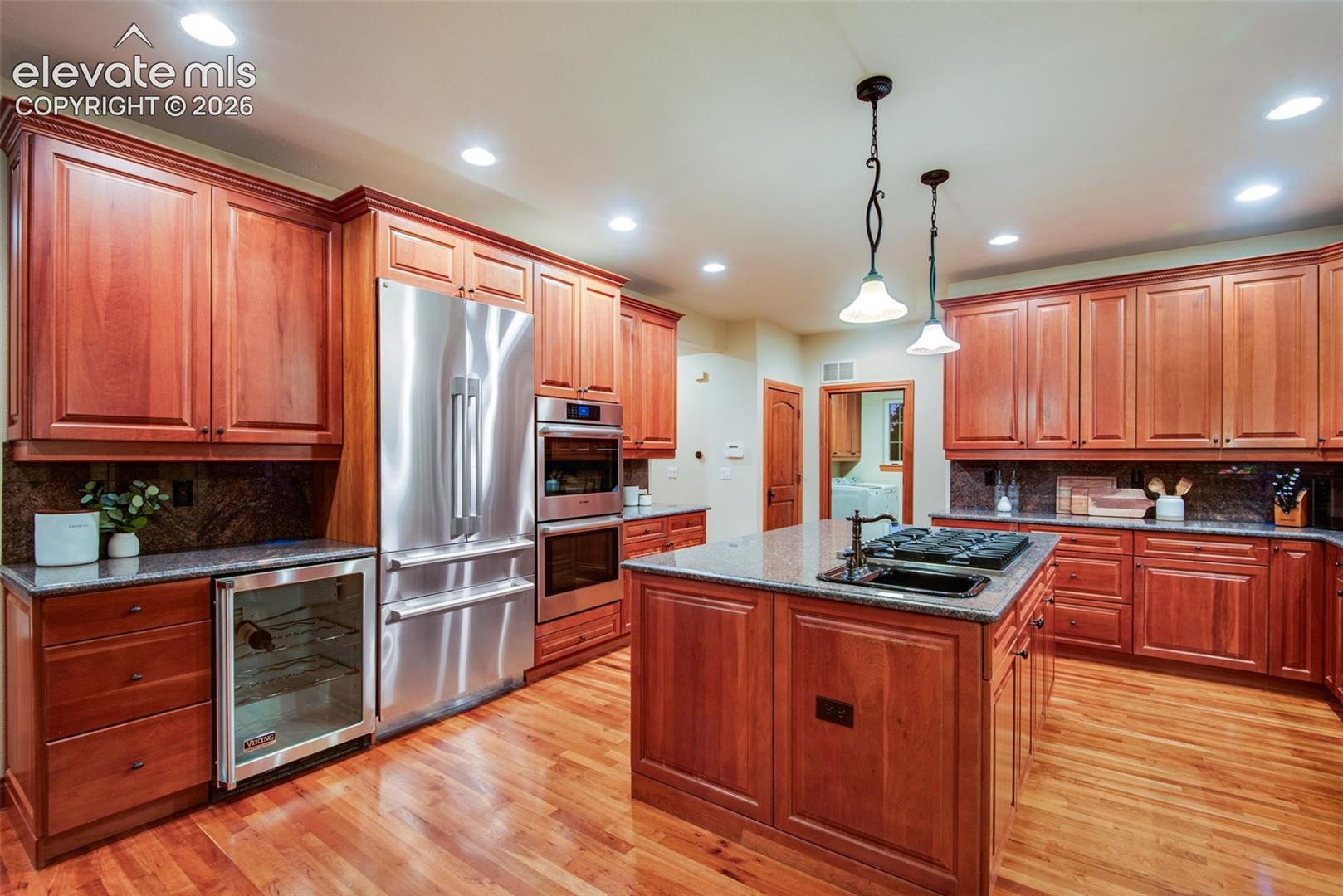 16075 Winding Trail Road Colorado Springs, CO 80908 - Photo 22 of 49 Kitchen with new (2025) built-in refrigerator and updated ovens