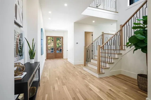 a view of an entryway with wooden floor and windows