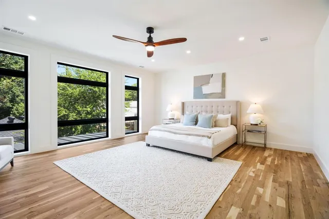 a spacious bedroom with a large bed and a large window