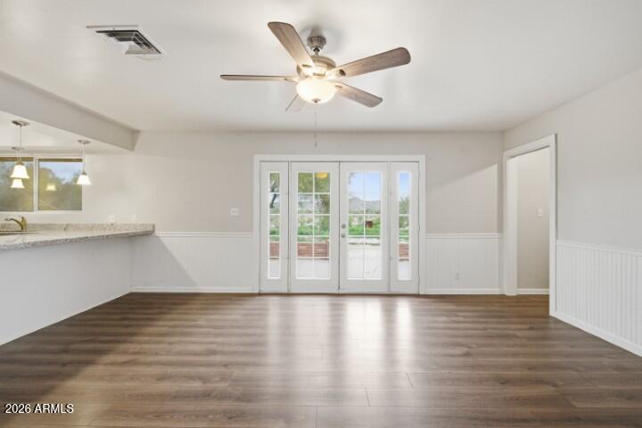 19402 West Lynx Road Buckeye, AZ 85326 - Photo 14 of 42 a view of an empty room with wooden floor and a window