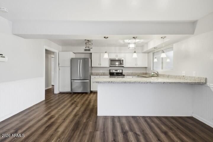19402 West Lynx Road Buckeye, AZ 85326 - Photo 15 of 42 a large kitchen with stainless steel appliances a large counter top a sink and a refrigerator