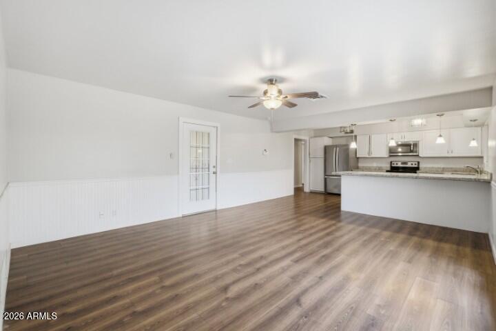 19402 West Lynx Road Buckeye, AZ 85326 - Photo 18 of 42 a view of a kitchen with a sink and a stove top oven