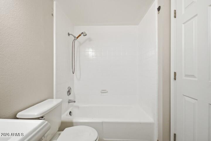 19402 West Lynx Road Buckeye, AZ 85326 - Photo 20 of 42 a bathroom with a toilet and a bathtub