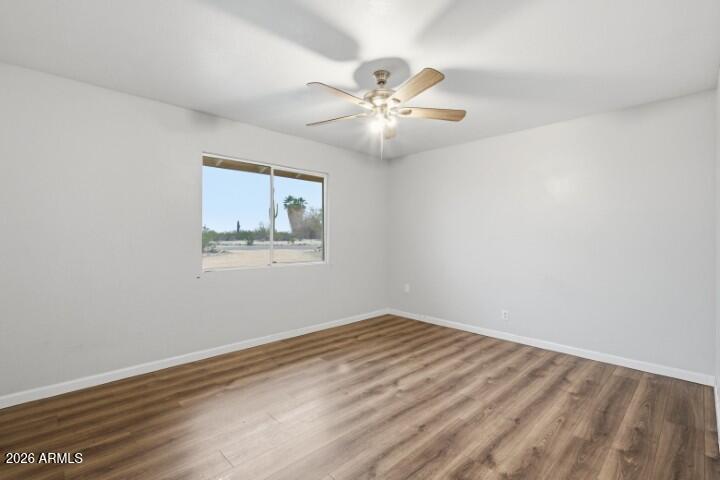 19402 West Lynx Road Buckeye, AZ 85326 - Photo 23 of 42 a view of an empty room with wooden floor