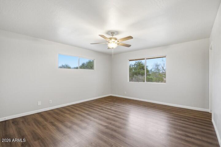 19402 West Lynx Road Buckeye, AZ 85326 - Photo 25 of 42 an empty room with wooden floor and ceiling fan
