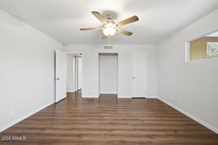 19402 West Lynx Road Buckeye, AZ 85326 - Photo 27 of 42 a view of an empty room with wooden floor
