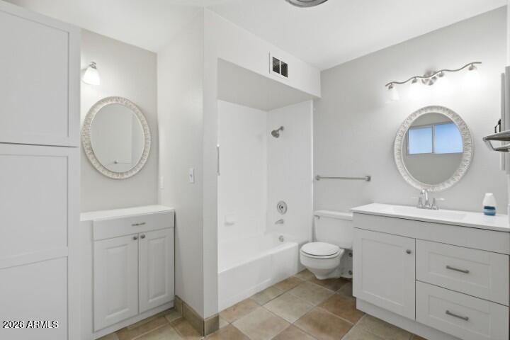 19402 West Lynx Road Buckeye, AZ 85326 - Photo 28 of 42 a bathroom with a toilet a sink and a mirror