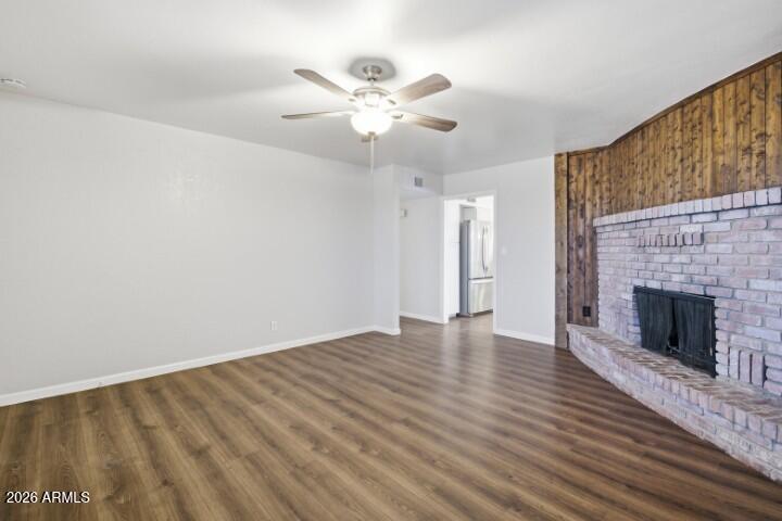 19402 West Lynx Road Buckeye, AZ 85326 - Photo 5 of 42 a view of an empty room with wooden floor fireplace and a window