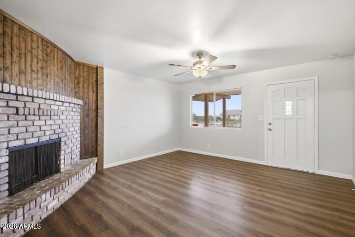 19402 West Lynx Road Buckeye, AZ 85326 - Photo 7 of 42 wooden floor in an empty room with a fireplace