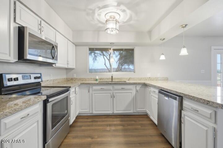 19402 West Lynx Road Buckeye, AZ 85326 - Photo 9 of 42 a kitchen with granite countertop stainless steel appliances a stove sink and microwave