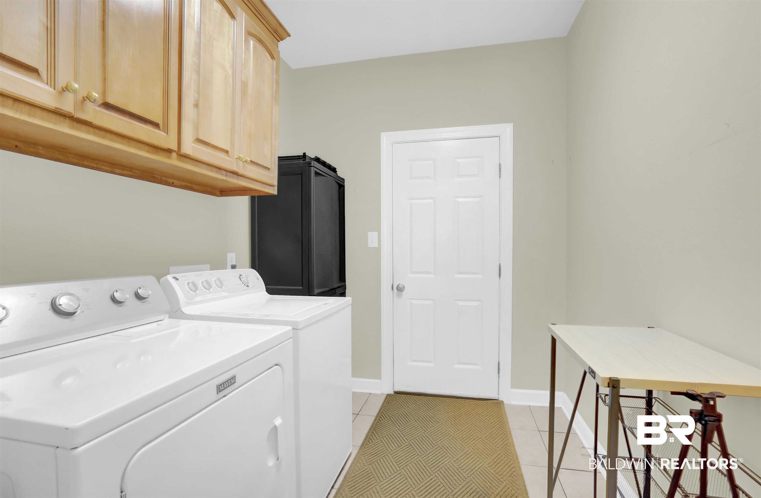 100 Conti Court Fairhope, AL 36532 - Photo 47 of 54 Laundry area with cabinets, light tile patterned floors, and washing machine and clothes dryer