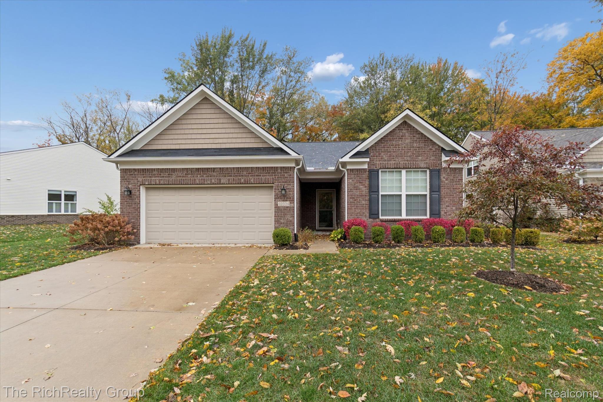 49534 Mapleton Road Canton, MI 48188 - Photo 3 of 37 Ranch-style house with a front yard, concrete driveway, brick siding, and an attached garage