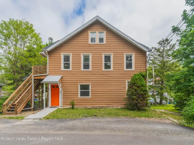 a front view of house with yard and green space