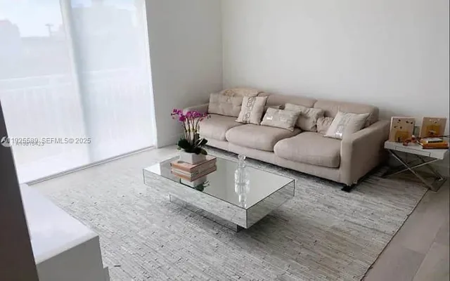 a living room with furniture and a rug