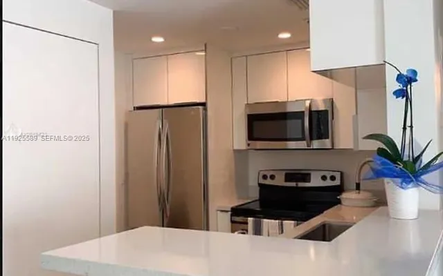 a kitchen with stainless steel appliances a refrigerator and a sink