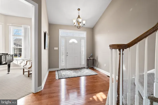 a view of a hallway view with wooden floor and staircase
