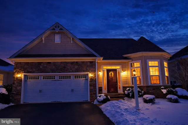 a front view of a house with large windows