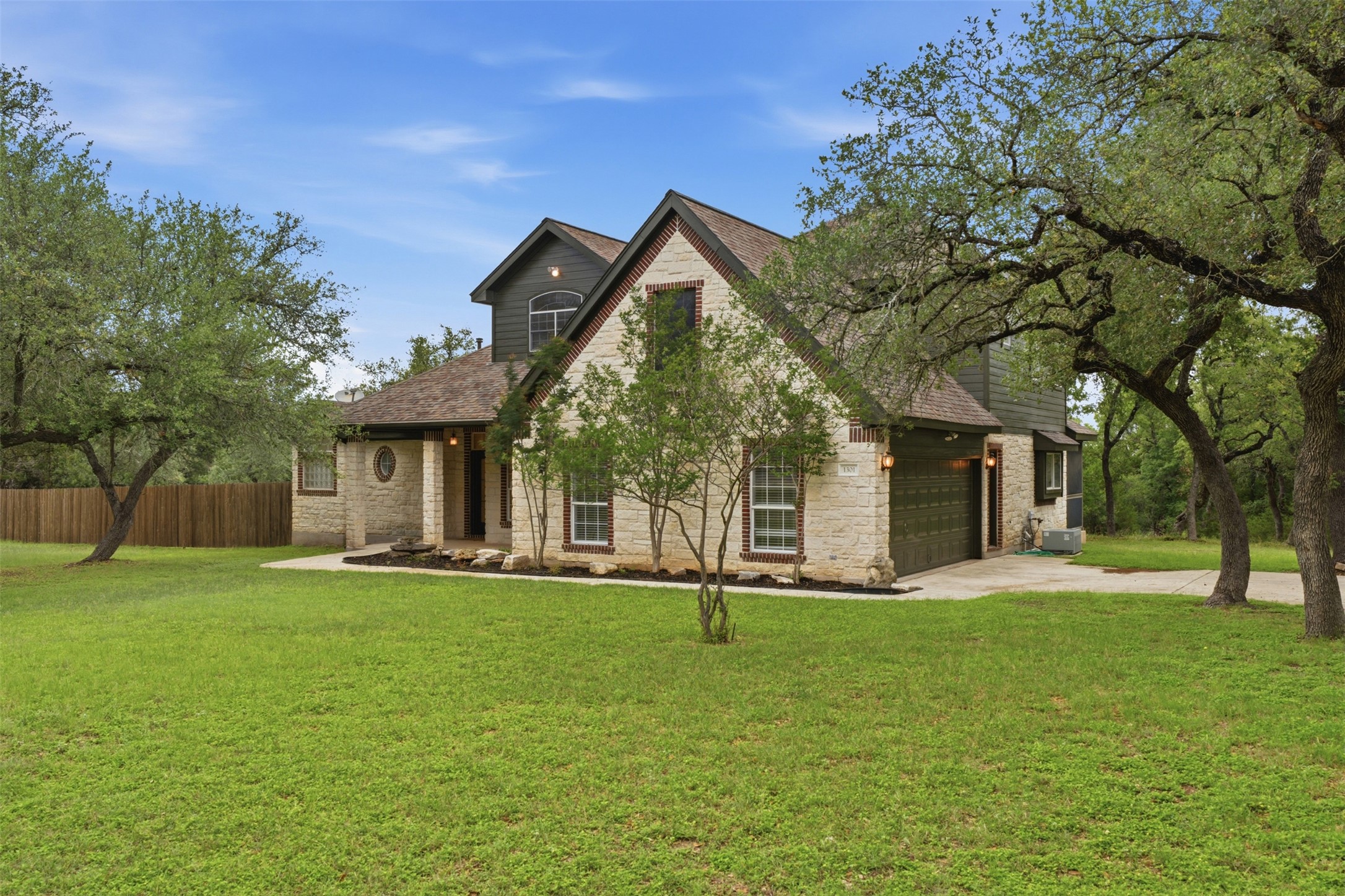 1301 County Road 262 Georgetown, TX 78633 - Photo 2 of 39 Stone and siding exterior with dark trim accents