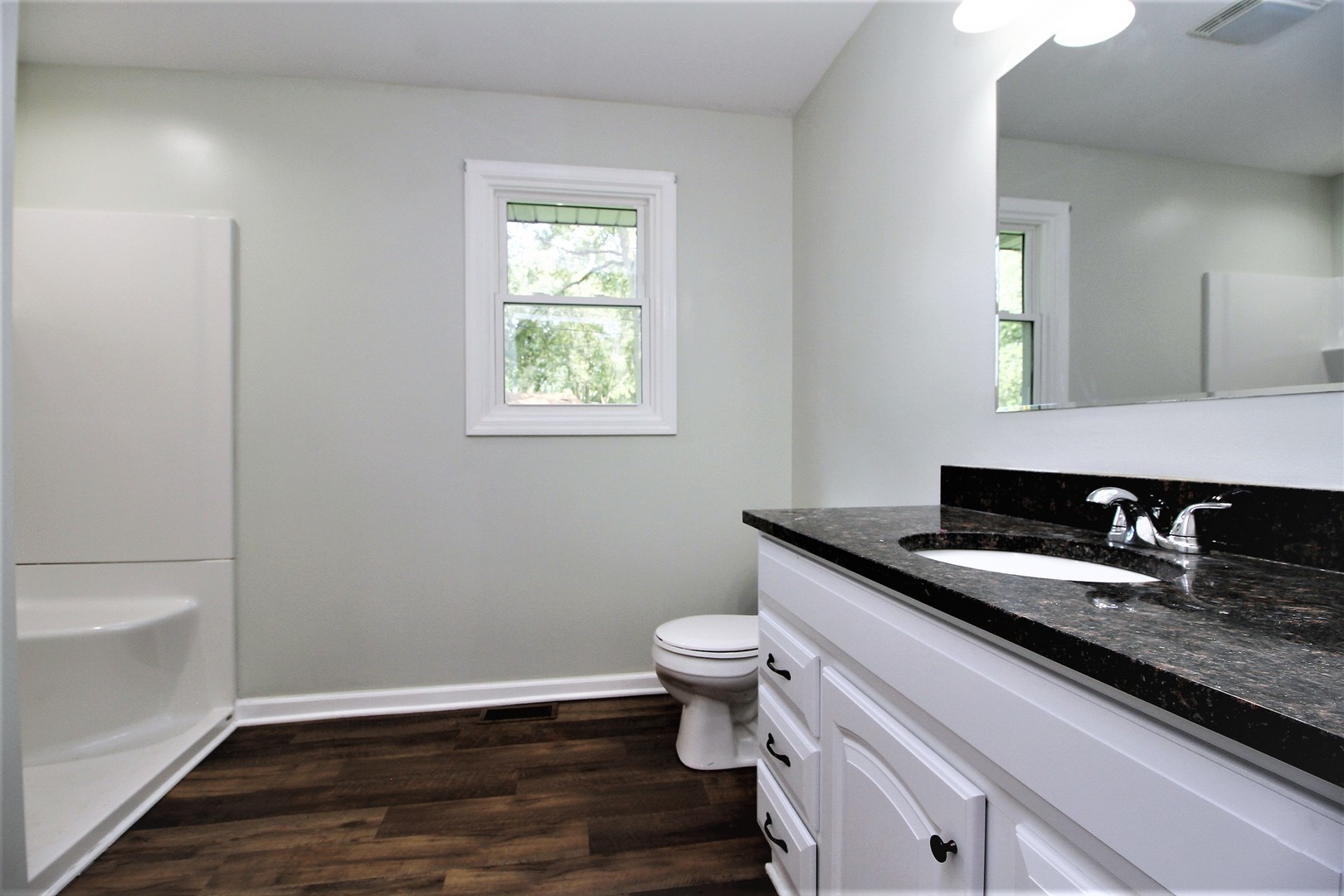 89 South 3120W Road Kankakee, IL 60901 - Photo 8 of 14 a bathroom with a granite countertop toilet a sink and a mirror