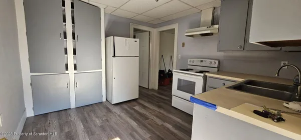 a kitchen with a refrigerator and a stove
