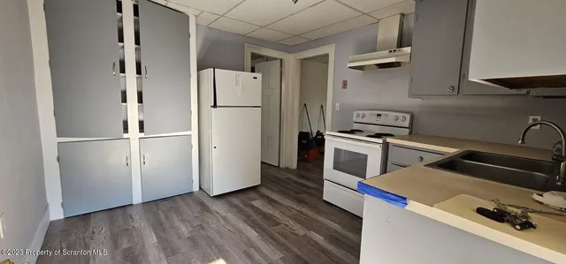 a kitchen with a refrigerator and a stove