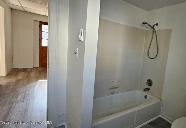 a bathroom with a bathtub and shower
