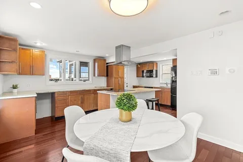 a dining room with furniture and wooden floor