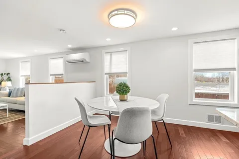 a view of a dining room with furniture window and wooden floor