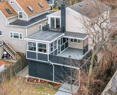 a view of a house with a wooden deck