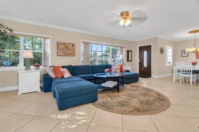a living room with furniture and a chandelier