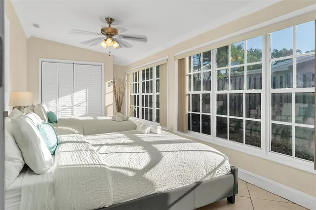 a bedroom with a bed and a large window