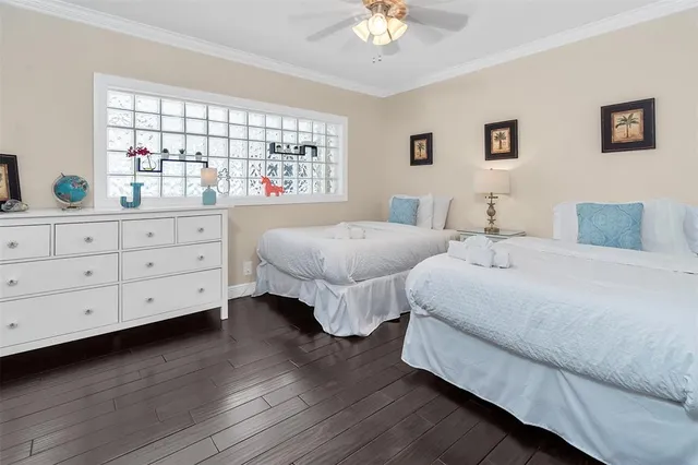 a bedroom with two beds and a window