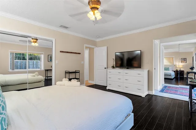 a bedroom with a bed and a flat screen tv